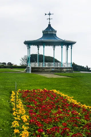 bandstand: a small, open-air platform or enclosure for bands to play on, usually roofed