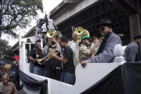 bandwagon: a large wagon used to carry a band of musicians in a parade