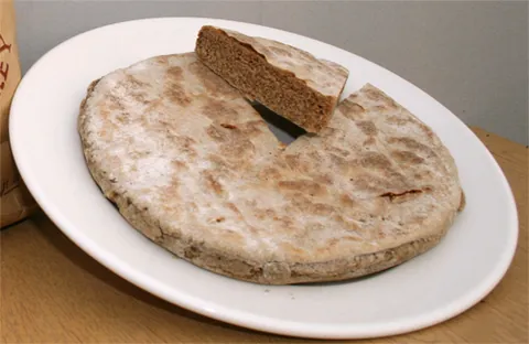 bannock: an unleavened bread, usually made with barleymeal, wheatmeal, or oatmeal; sometimes of peasemeal or...