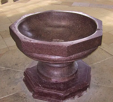 baptismal font: a large basin used for baptism in or near a church
