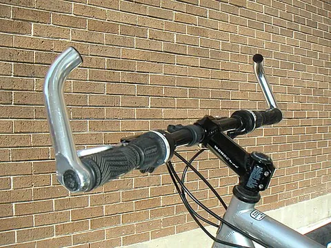 bar end: an extension attached to the end of a bicycle handlebar, usually to increase leverage for climbing