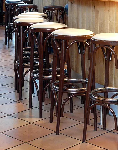 bar stool: a stool used for sitting, often taller than a chair and usually having a foot rest, commonly placed...