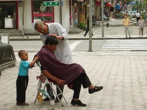 barber: a person whose profession is cutting the hair and beards of usually male customers