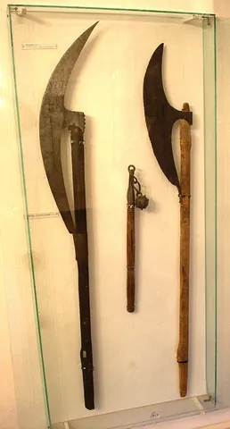 bardiche: a poleaxe with a long blade that extends beyond the shaft