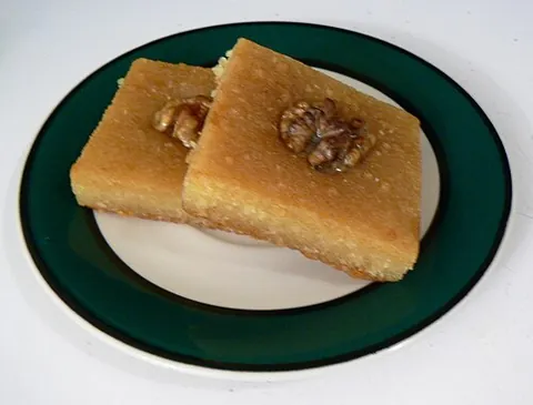 basbousa: a traditional Middle Eastern sweet cake, made from cooked semolina or farina soaked in simple syrup...