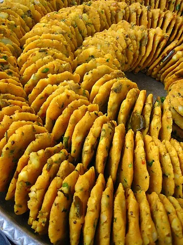 batata vada: a popular vegetarian fast food in Maharashtra, India, consisting of a potato mash patty coated with...