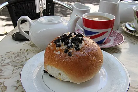 bath bun: a small, round baked good, having a bread-like consistency, topped with sugar or icing and...