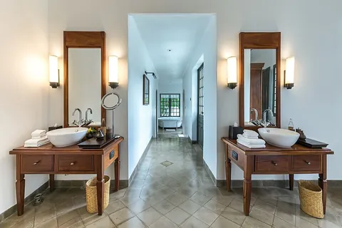 bathroom: a room containing a shower or bathtub, and (typically but not necessarily) a toilet