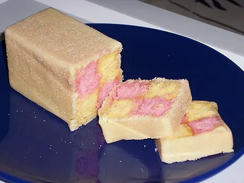 battenberg cake: a light sponge cake which, when cut in cross section, displays a two-by-two check pattern...