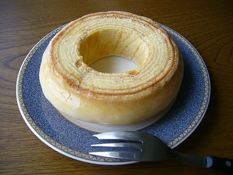 baumkuchen: a kind of layer cake, traditionally baked on a spit, in which the layers resemble concentric tree...