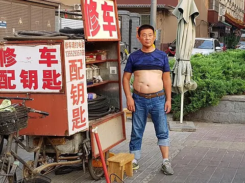 beijing bikini: a rolled-up T-shirt that bares the wearer's midriff, a means of cooling down in the sweltering heat...