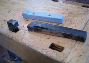 bench dog: a peg placed in a hole in a workbench to clamp a workpiece in place