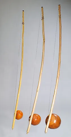 berimbau: a percussion instrument, consisting of a gourd (as resonator) and a single wire stretched along a...