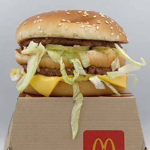 big mac: a hamburger from the fast food company McDonald's, served on a three-part bun with various...