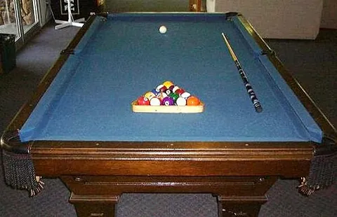 billiard table: a heavy felt-covered table fitted with six pockets along the perimeter used in the games of pool,...
