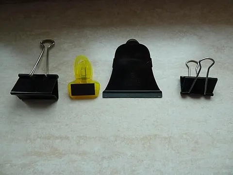 binder clip: a simple device for binding several sheets of paper, leaving the sheets intact; a strip of spring...