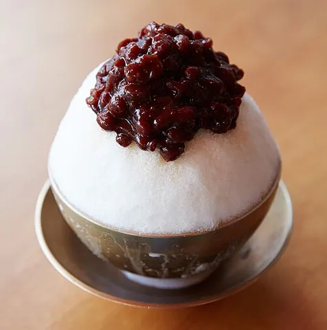 bingsu: a Korean shaved ice dessert with sweet toppings that may include chopped fruit, condensed milk,...