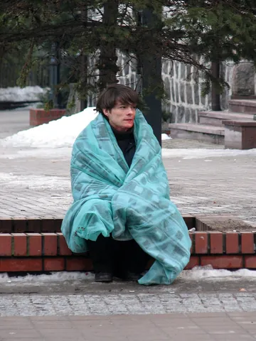 blanket: a heavy, loosely woven fabric, usually large and woollen, used for warmth while sleeping or resting