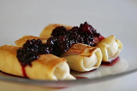 blintz: a thin blin (pancake), filled (often with sweet cheese) and folded, then fried and often served...