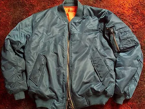 blouson: a garment drawn tight at the waist with blousing hanging over the waistband; a blouse jacket