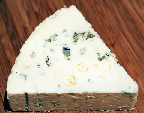 blue cheese: a kind of cheese made with bluish mold in it