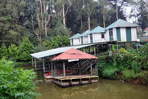boathouse: a building at the edge of a river, lake or other body of water in which boats are kept