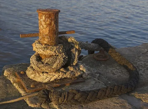 bollard: a strong vertical post of timber or iron, fixed to a wharf, dock, or the deck of a ship, to which...