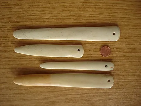 bone folder: a dull-edged hand tool used to fold and crease material in crafts