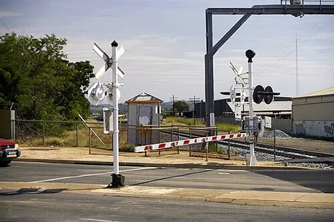 boom barrier: a bar or pole that can be lowered to block vehicular access through a controlled location, or...