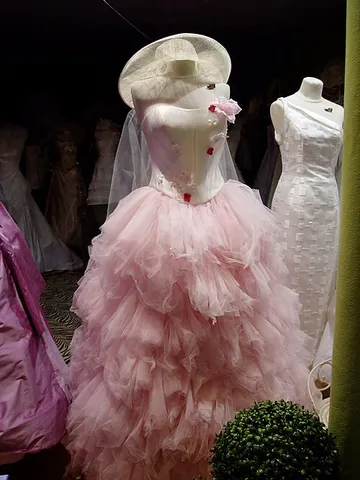 bouffant gown: a woman's evening gown that has a wide, full skirt, often of several layers