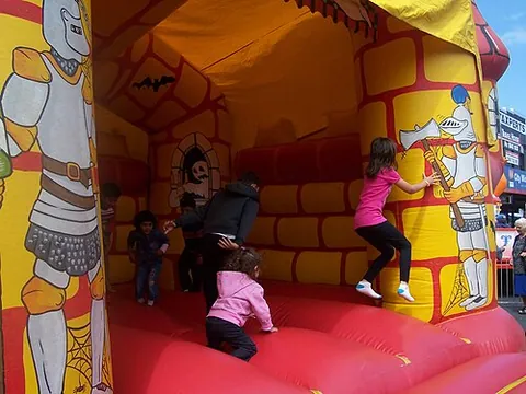 bouncing castle: a large inflatable structure, resembling a castle etc., on which children jump and play as on a...