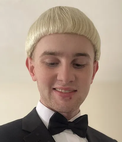 bowl cut: a haircut featuring a straight fringe across the front and the hair of even length around the rest...