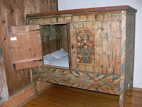 box-bed: a bed that is completely enclosed to provide the occupant with privacy, resembling a freestanding...