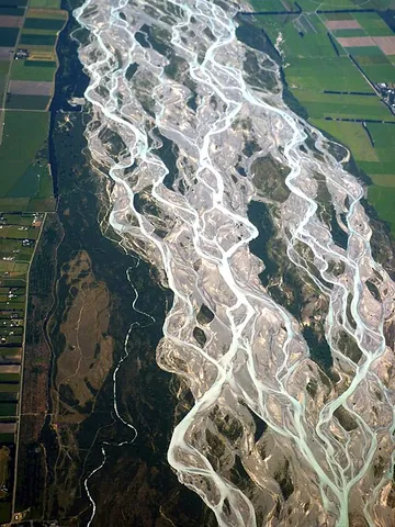 braided river: a river which has a network of channels which diverge and rejoin around (typically ephemeral) braid...