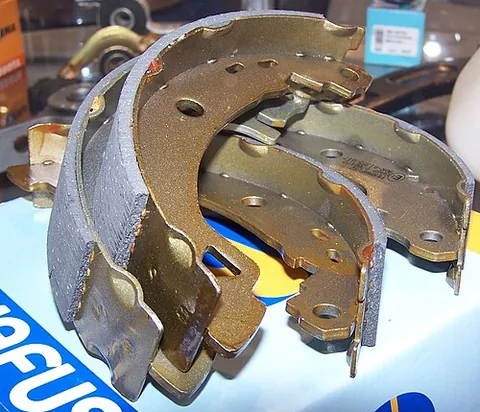 brake shoe: an element of a drum brake into which the friction-producing brake lining is attached