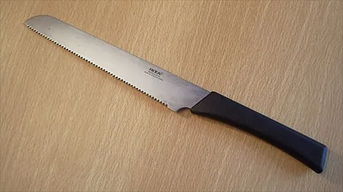 bread knife: a knife, with a serrated edge, designed to cut bread; sometimes slots into a breadboard