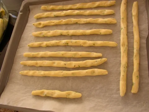 breadstick: a long, very slender loaf of crisp bread smaller than a baguette; for example, grissini from Italy...