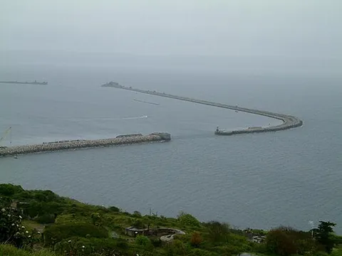 breakwater: a construction in or around a harbour designed to break the force of the sea and to provide shelter...