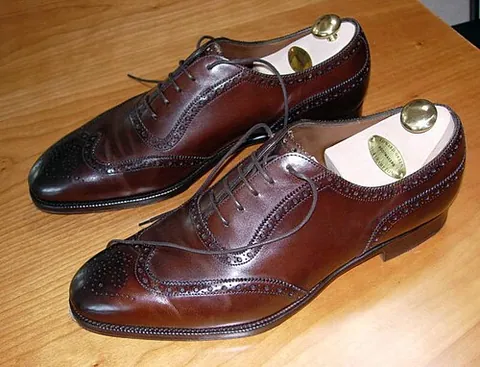 brogueing: a pattern of punch holes along the seams of a shoe, found in various styles of shoe, notably the...