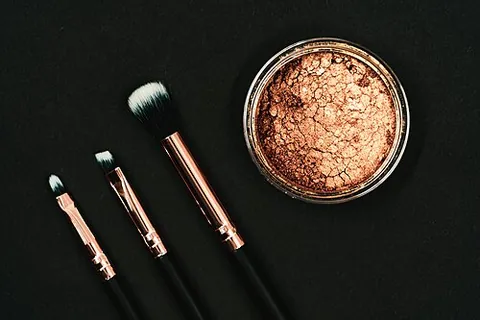 bronzer: a cosmetic product intended to give the skin a temporary bronzed colour resembling a suntan