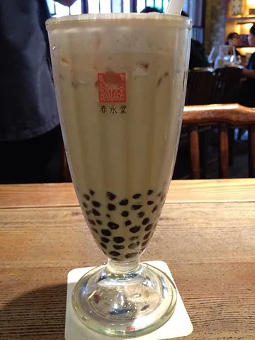 bubble tea: sweetened tea with milk and tapioca pearls, often including fruit juice, syrup and other ingredients