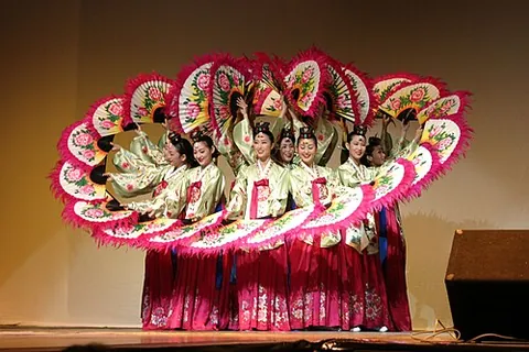 buchaechum: a Korean fan dance, usually performed by groups of female dancers, originating from various...