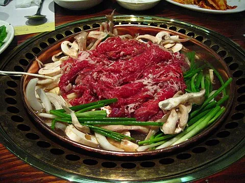 bulgogi: a Korean dish of shredded (usually marinated) beef with vegetables