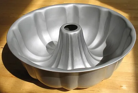 bundt: a baking pan with a hollow, circular, raised area in the middle