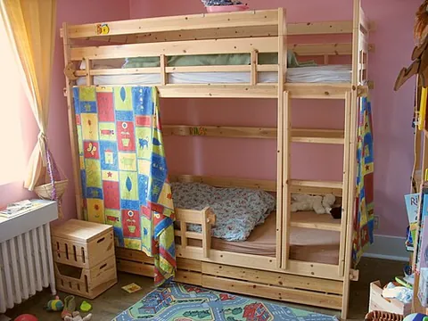 bunk bed: a type of furniture with two or more beds stacked vertically, one directly above the other, in...