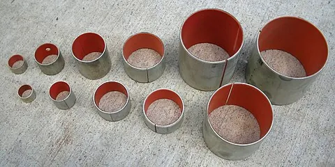 bushing: a type of plain bearing, a cylindrical lining designed to reduce friction and wear inside a hole,...