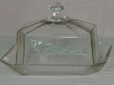 butter dish: a specialized dish for serving butter, typically consisting of a base with a separate fitting lid...
