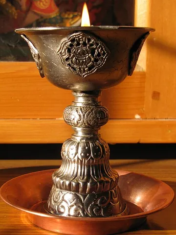 butter lamp: a lamp that is a common feature of Tibetan Buddhist temples and monasteries throughout the Himalayas