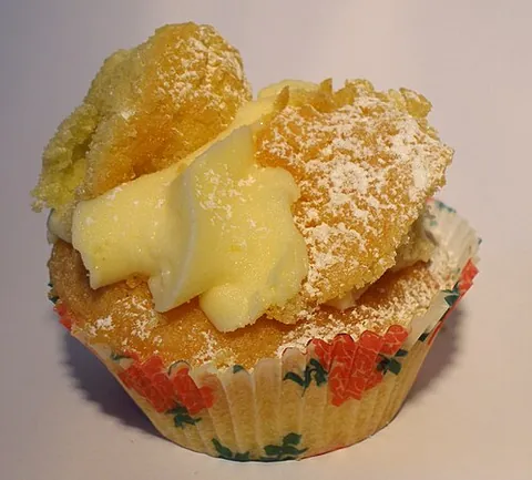 butterfly cake: a cupcake whose top section is cut out and replaced on a layer of butter cream, etc. in the...