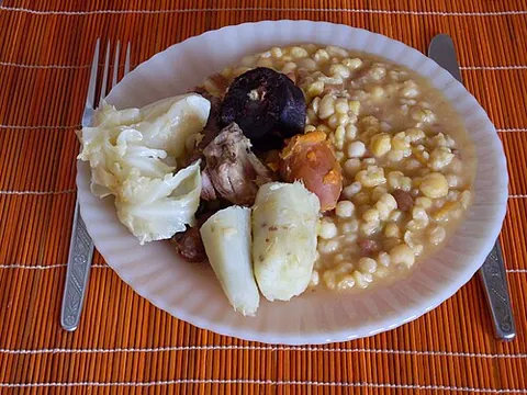 cachupa: a slow-cooked stew of hominy, beans, cassava, sweet potato, and fish or meat, a traditional dish of...